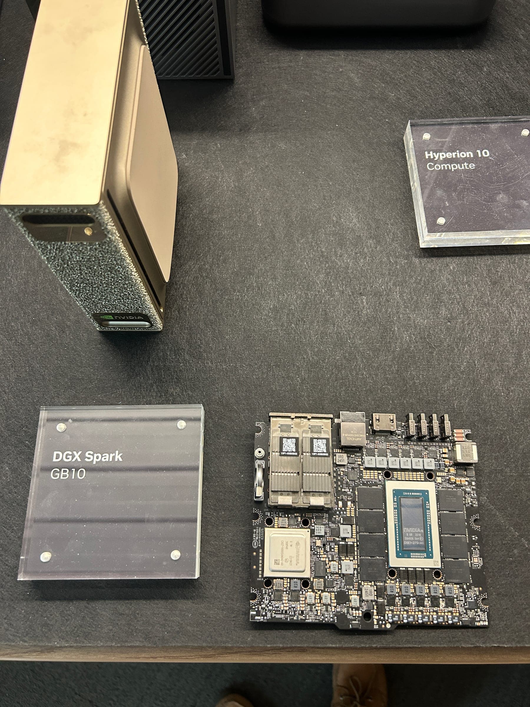 An exposed GB10 Grace Blackwell board on display next to a DGX Spark